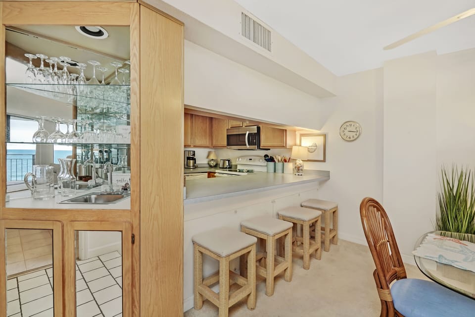 Your open kitchen welcomes you with warm wood tones, convenient breakfast bar seating, and all the essentials for comfortable cooking.
