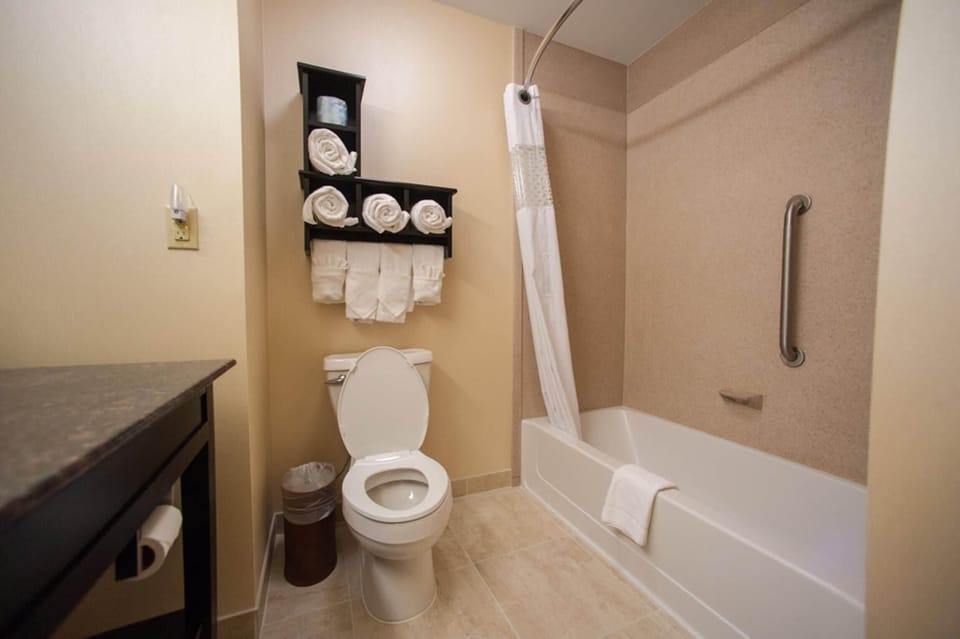 Suite, 1 King Bed | Bathroom | Hair dryer, towels
