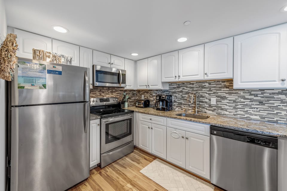 Stainless Steel Appliances and beautiful Backsplash.
