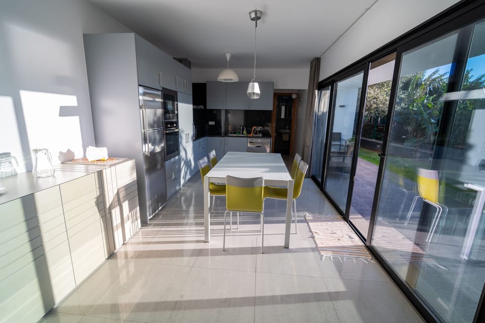Kitchen area with large sliding doors connects inside with the nature outside