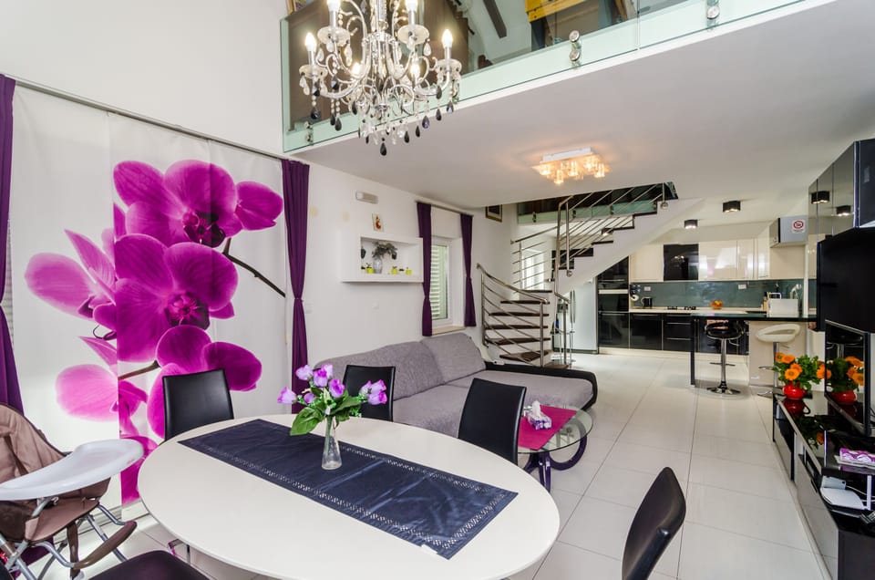 Apartment (Four Bedroom Duplex Apartment) | Living room | 25-inch flat-screen TV with cable channels, TV, DVD player