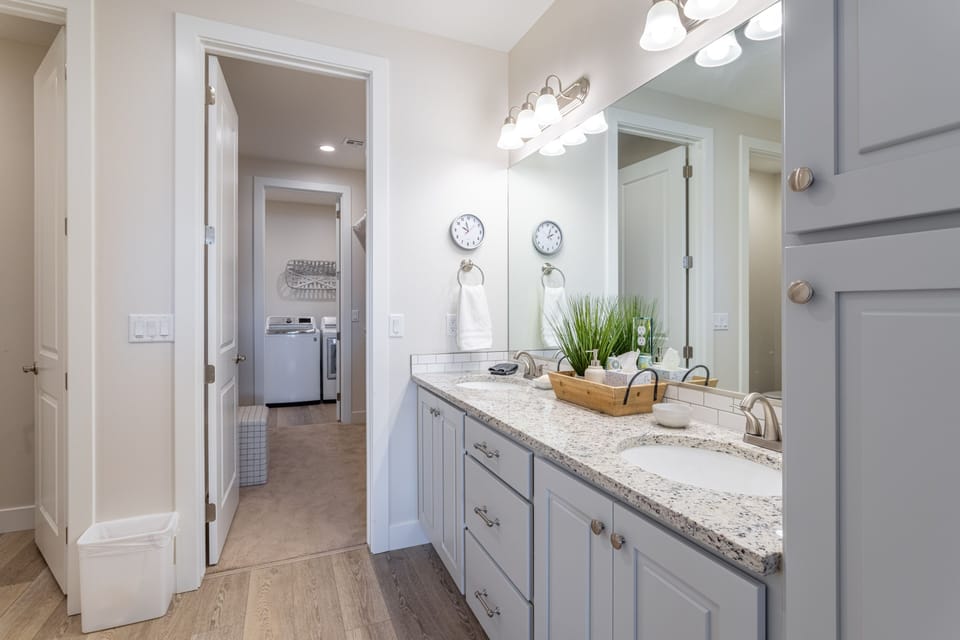 Main Bathroom - With access to the walk-in closet and laundry room this large and spacious bathroom also includes a walk-in shower, bath tub, his and her sinks, toilet and large vanity.