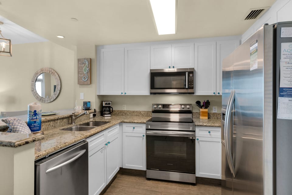Kitchen - Features stainless steel side by side refrigerator, stove, microwave, dishwasher, toaster, and cooking ware you may need during your stay.
