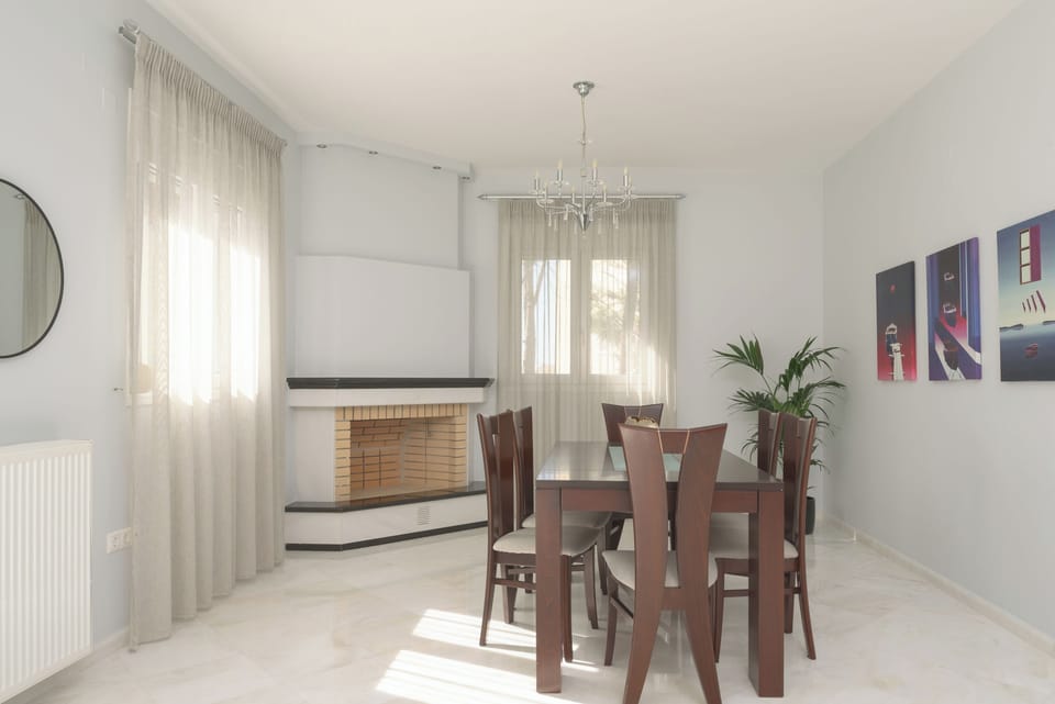 The living room area has an open fireplace and opens to a balcony. 