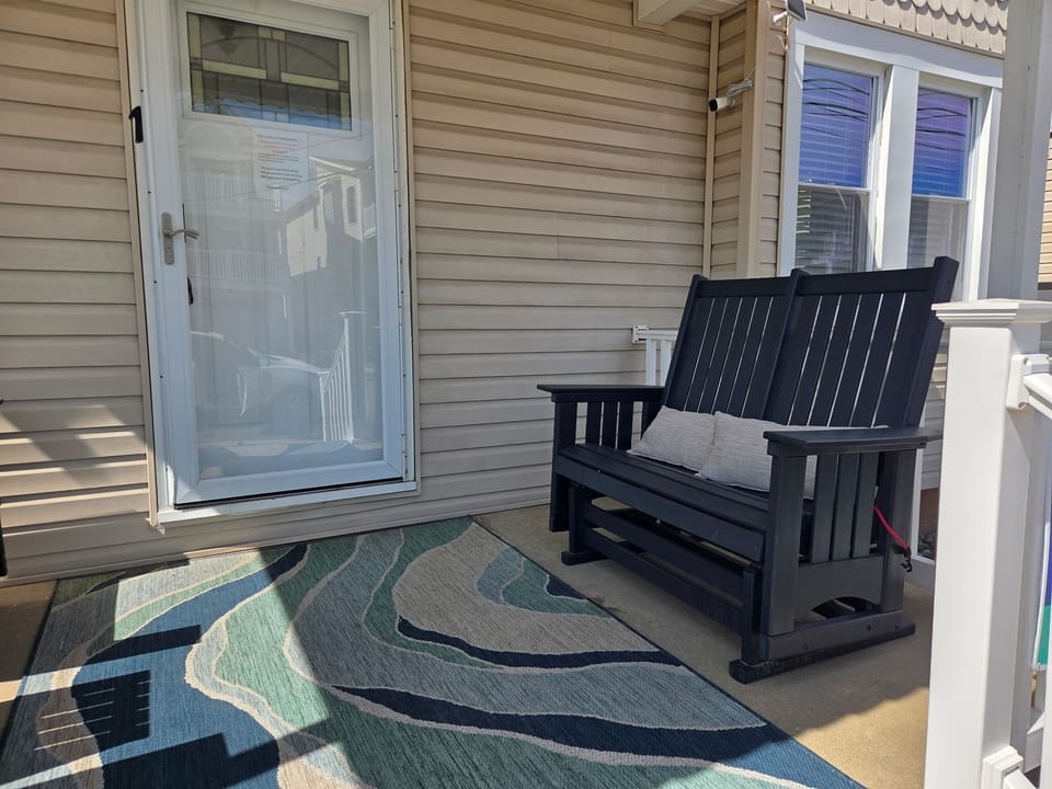 Private covered porch with gliding bench