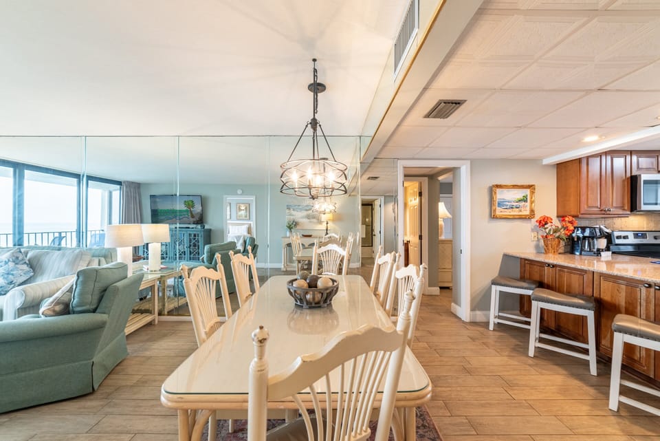 The dining table comfortably seats 8 with additional seating at the bar