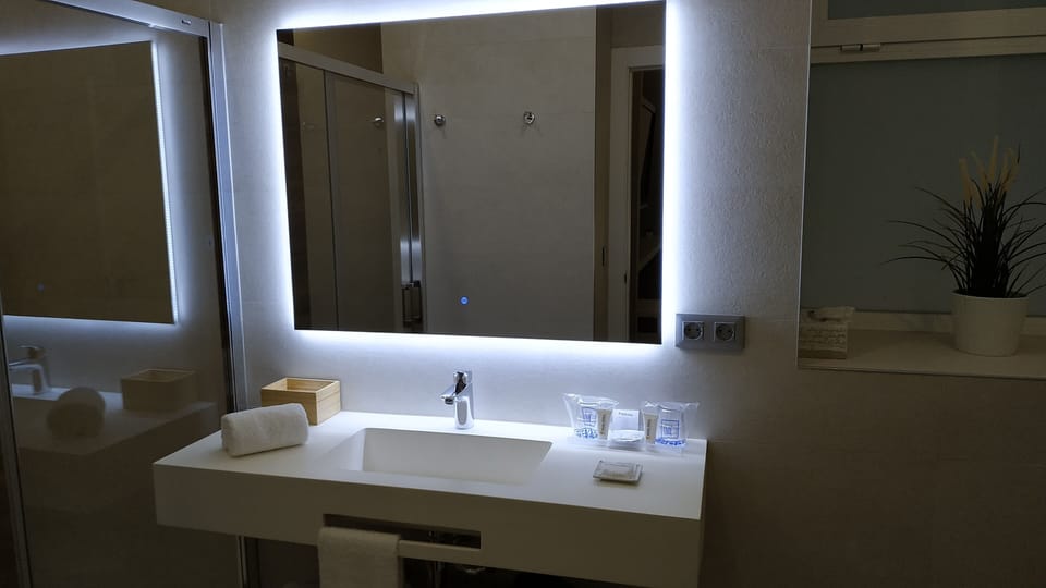 Junior Suite, City View | Bathroom | Eco-friendly toiletries, hair dryer, towels, soap