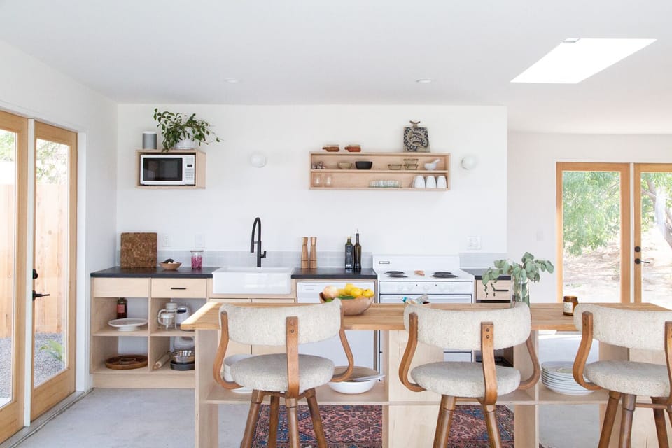 Kitchen and butcher top bar open up to the courtyard & living room/dining room