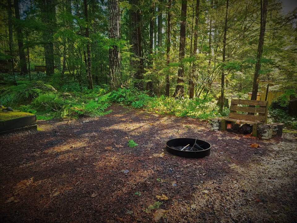 Fire Pit area with a cooking grate and lots of chairs