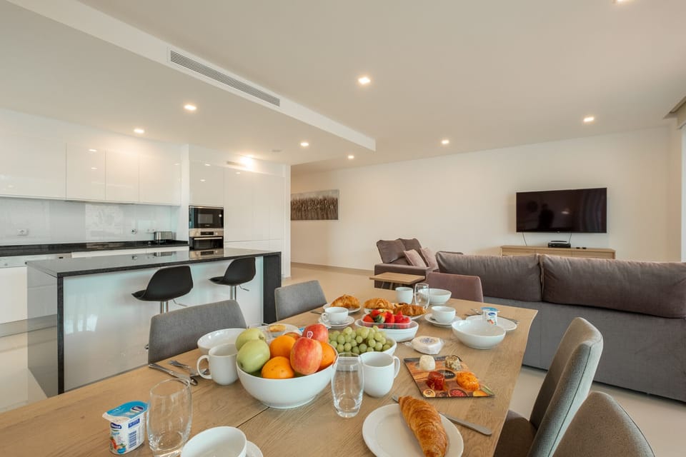 View of dining table, kitchen and living room