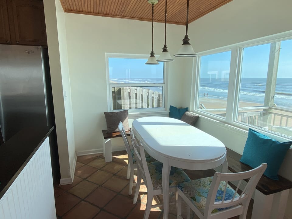 Dining room table with bench seating overlooking the ocean