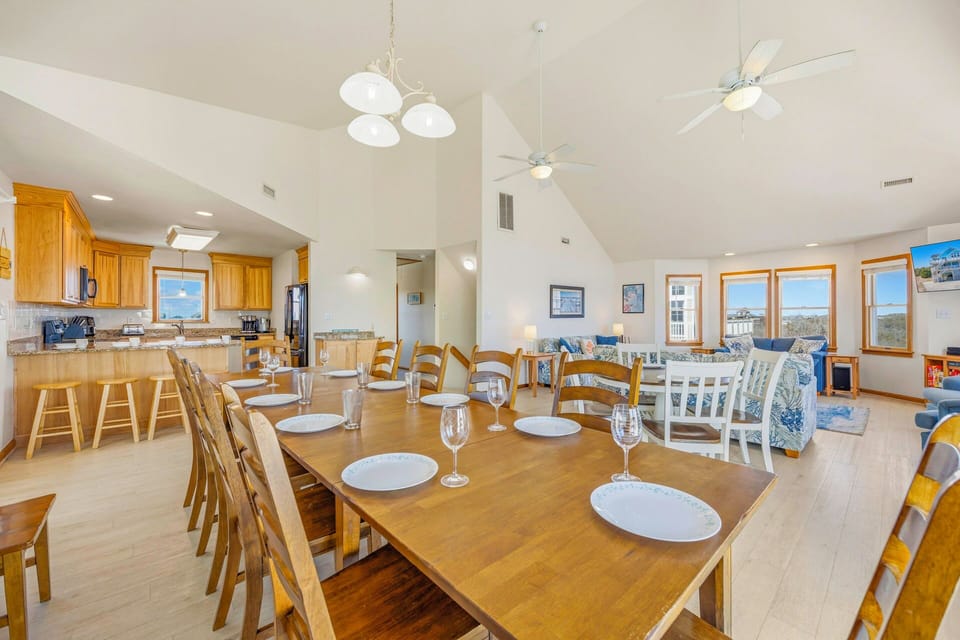 Gather around this spacious dining table where your group can share memorable meals together in this bright, open-concept space.