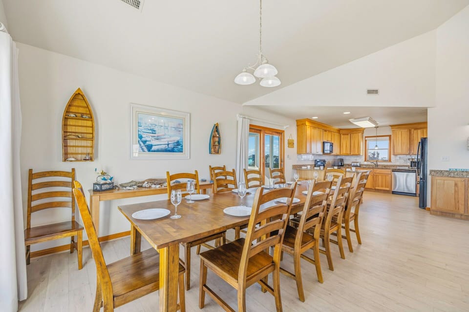 Gather your group around this spacious dining table where shared meals become cherished memories in your coastal retreat.