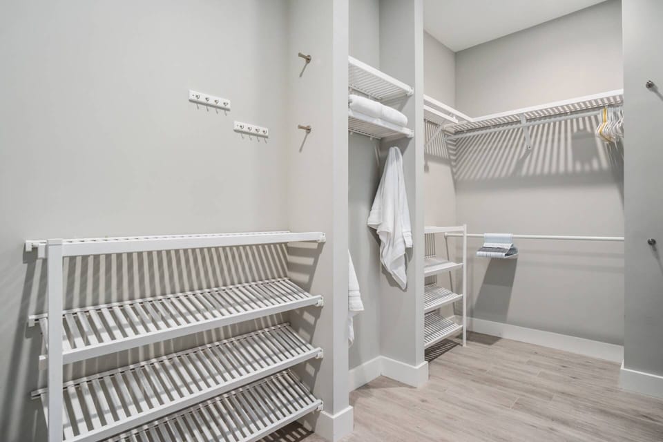 The spacious master closet it located just beyond the dual vanities in the ensuite bath.
