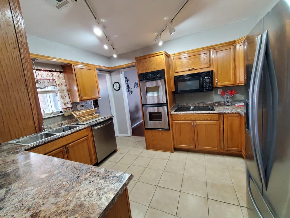 Kitchen with double ovens,ceramic cooktop,microwave,dishwasher,fridge