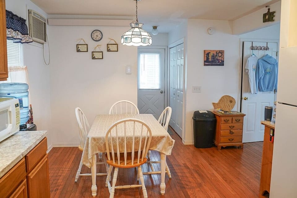 Kitchen highlights include seating for 4-6, a Keurig coffee machine with provided pods, a dishwasher, complimentary pure spring water dispenser, a microwave, a toaster oven, and plenty of various baking dishes, utensils, and spices.