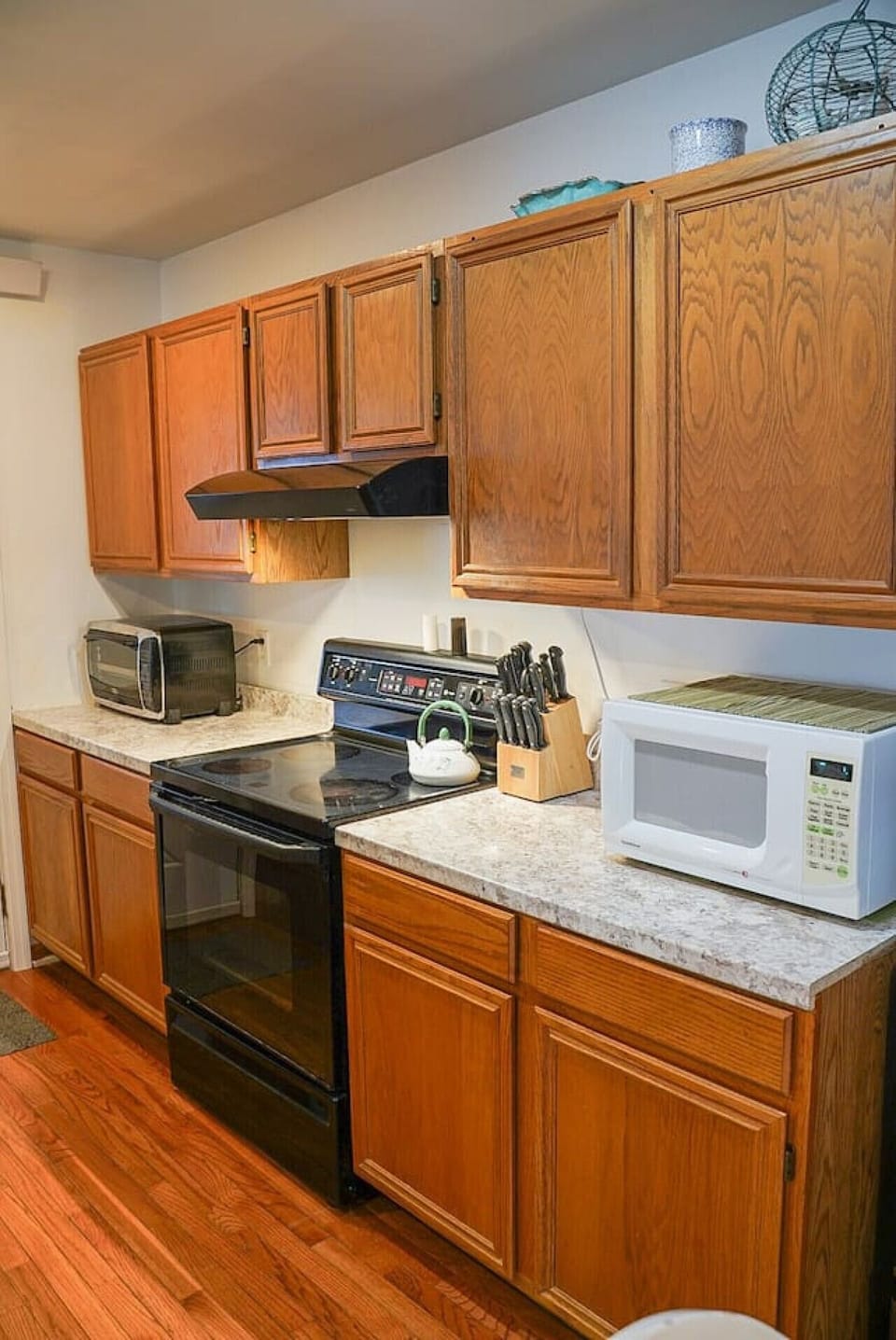 Kitchen highlights include seating for 4-6, a Keurig coffee machine with provided pods, a dishwasher, complimentary pure spring water dispenser, a microwave, a toaster oven, and plenty of various baking dishes, utensils, and spices.