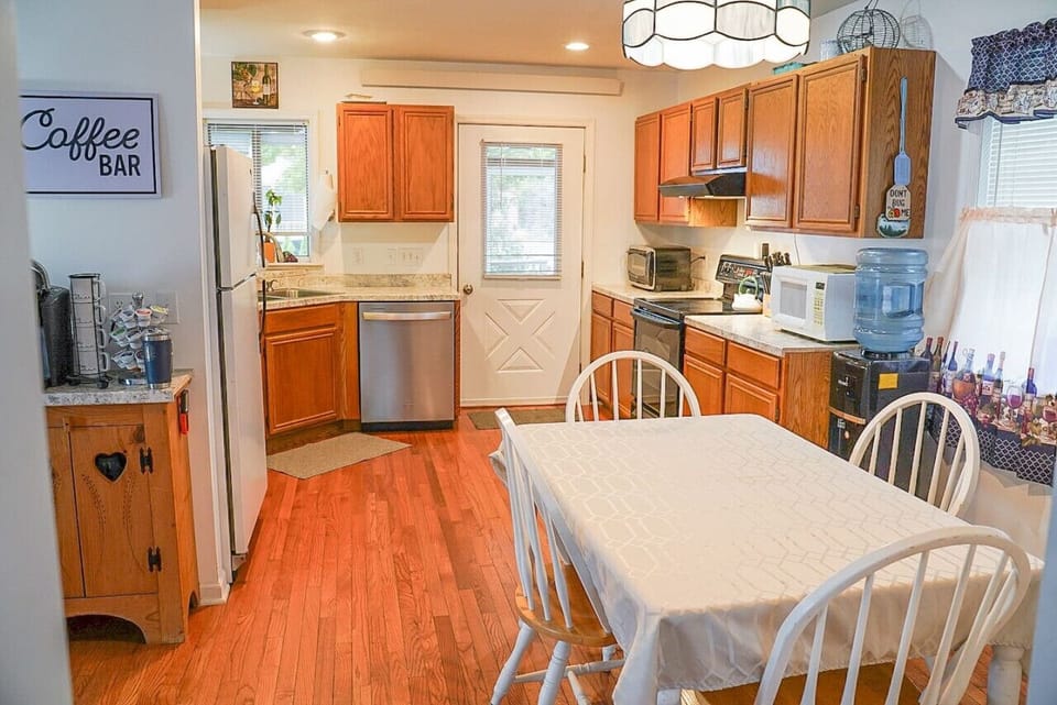 Upon entrance from the screened in porch you`ll find a fully stocked kitchen with seating for 4-6