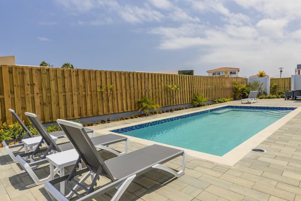 This incredible property features a large private swimming pool as well as a lush and tropical garden.
