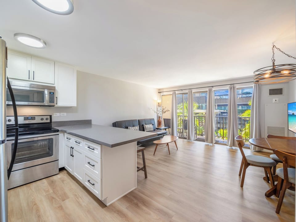 Living Room and Kitchen - Enjoy an easy flow between the kitchen and living room, designed for comfort and connection during your stay at Four Paddle.
