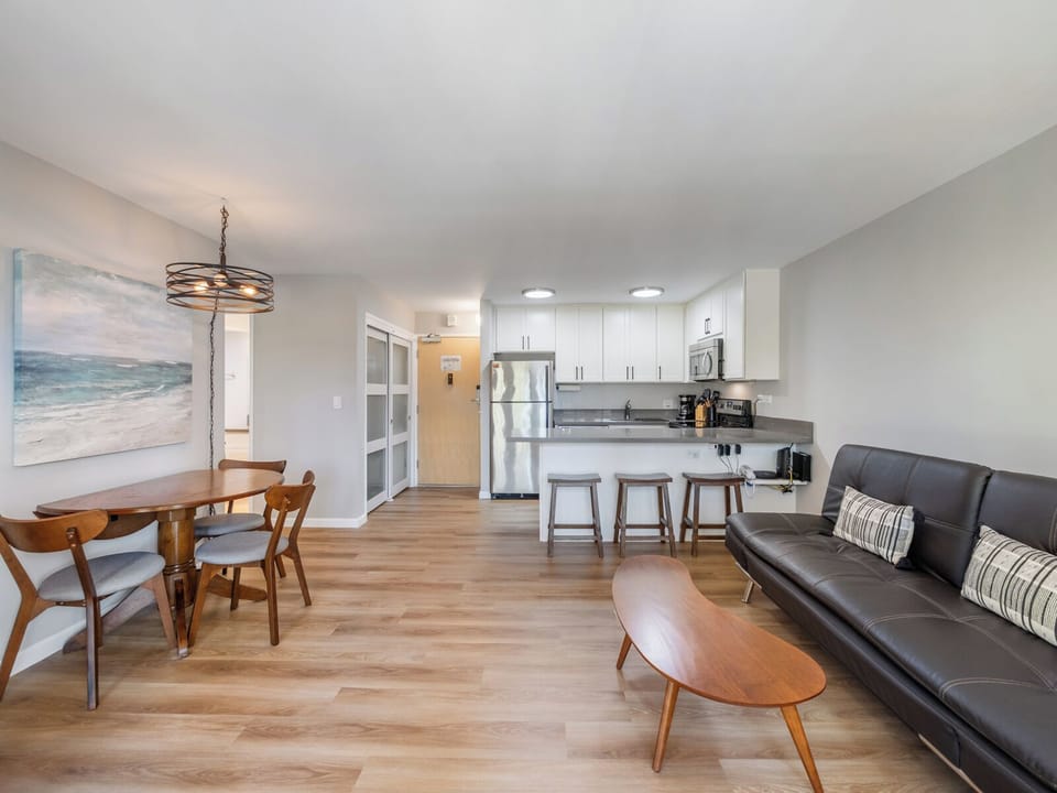 Living Room and Dining Area - Spacious and filled with natural light, the open living and dining area offers plenty of room to unwind before heading out to explore Waikiki’s restaurants and shops.