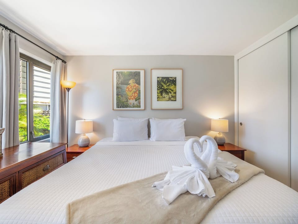 Bedroom - A touch of aloha—your bedroom welcomes you with a plush king bed, fresh linens, and tropical views framed by Waikiki palms.