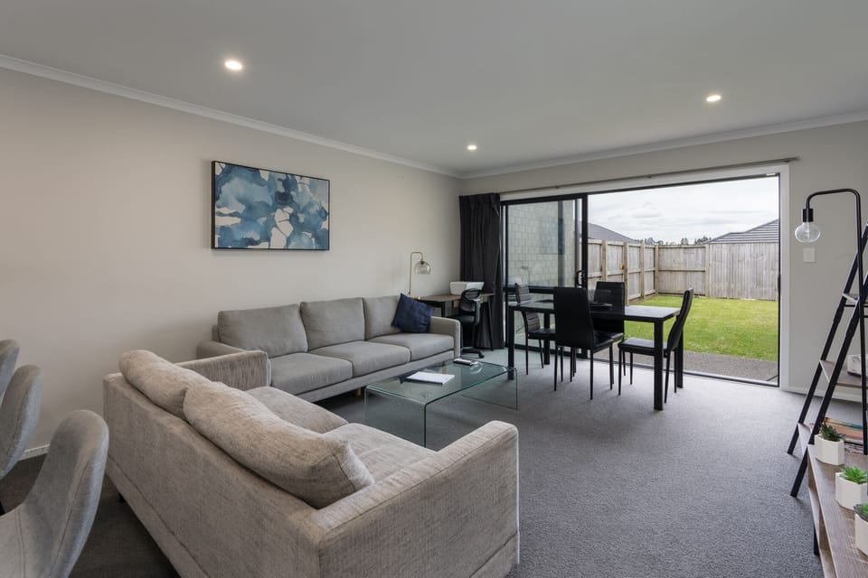 Lounge and dining area, with a wide opening ranch slider.