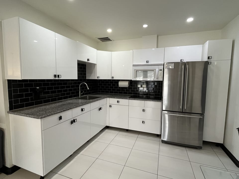 Sleek modern kitchen with stainless appliances near beach & downtown