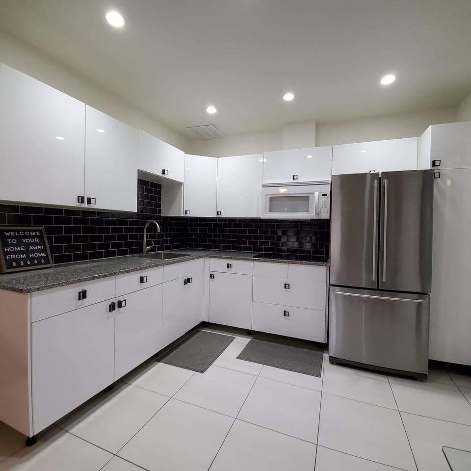 Modern mother-in-law suite kitchenette with full-size appliances.