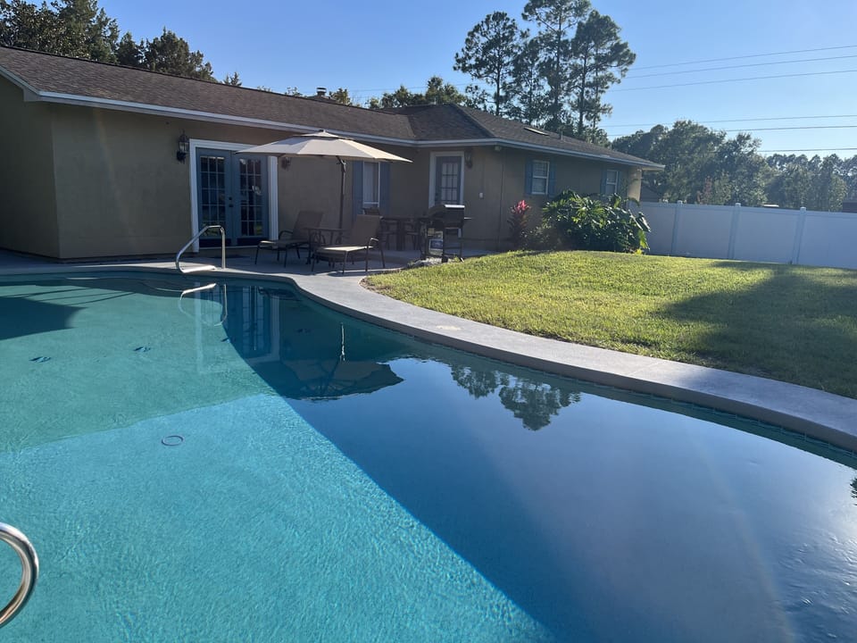 Private heated pool with patio seating—relax and enjoy the sunshine.