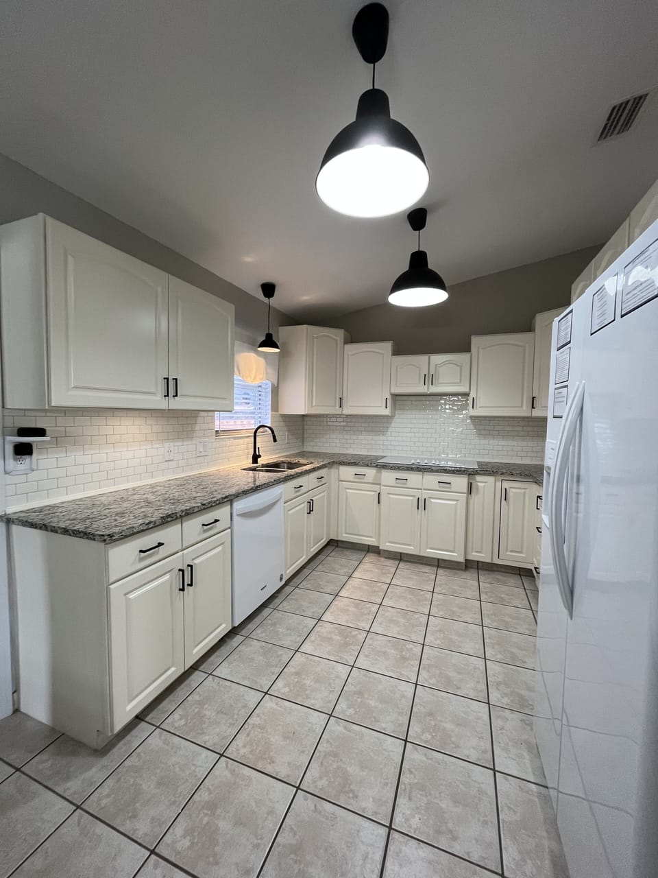 Spacious full-equpped kitchen with granite counters and all essentials.