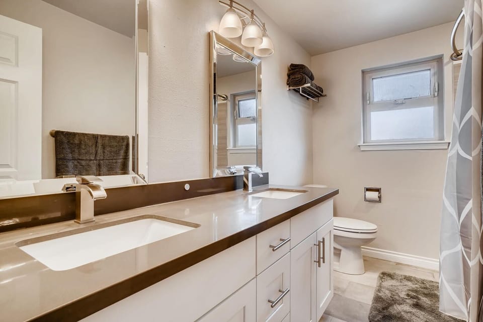 Upstairs Bathroom with Double sink and bathtub shower combo