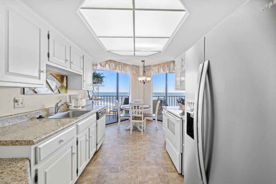Enjoy the fully stocked kitchen with a view.