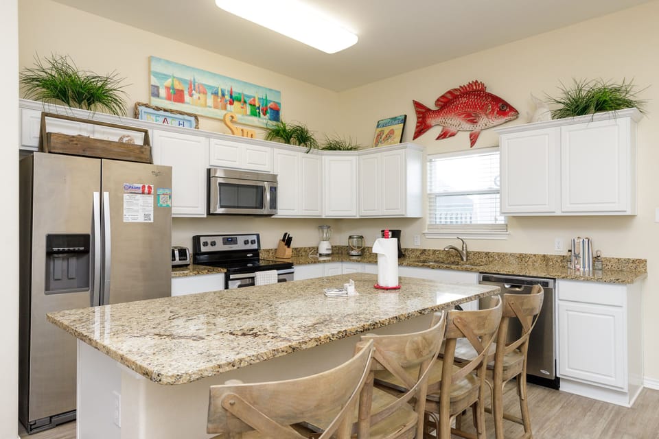 Cook memorable meals in your fully-equipped kitchen featuring granite countertops, stainless appliances, and a spacious island perfect for gathering.