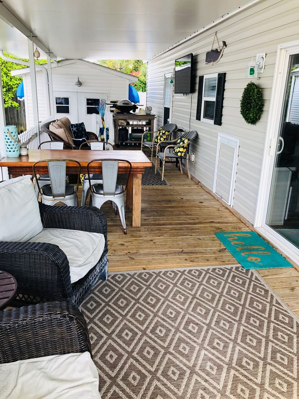 Outdoor porch with smart tv and Weber grill perfect for steaks