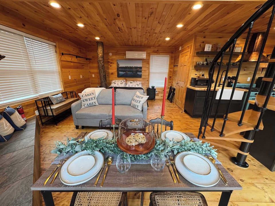 Charming Open Layout – A warm, inviting space where the dining area, cozy seating, and bed come together—ideal for relaxed evenings and memorable meals.