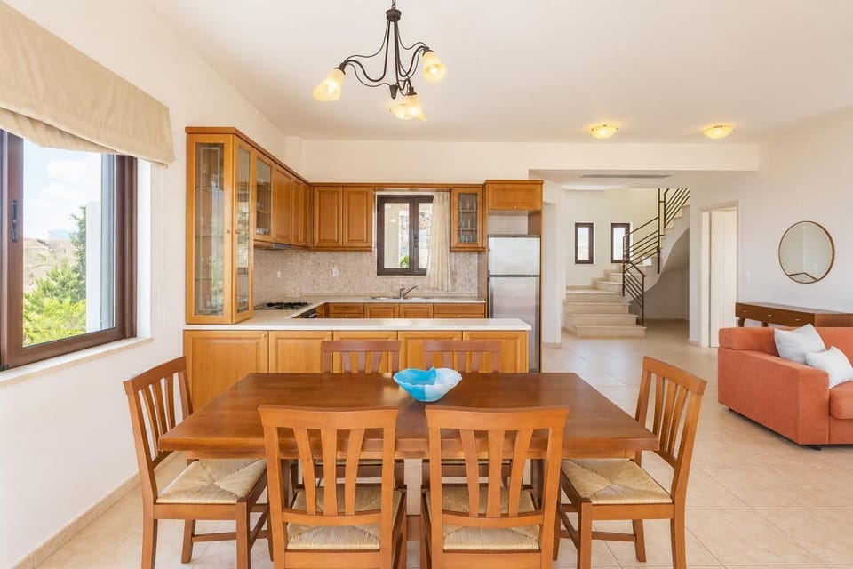 Open-plan living room with sofa, dining area, equipped kitchen, ornamental fireplace, WiFi internet, satellite TV, DVD player, and terrace access
