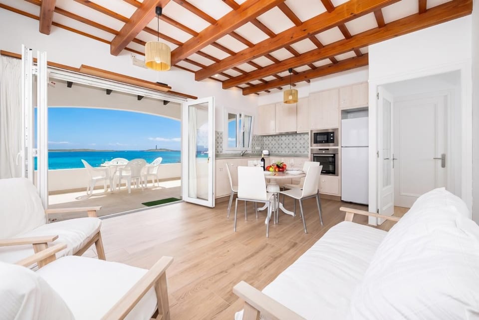 Living room with seating, dining area, kitchen, WiFi internet, satellite TV, and sea views
