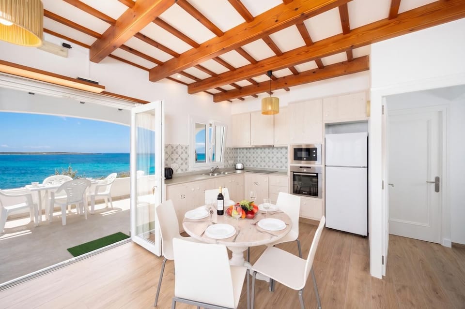 Living room with seating, dining area, kitchen, WiFi internet, satellite TV, and sea views