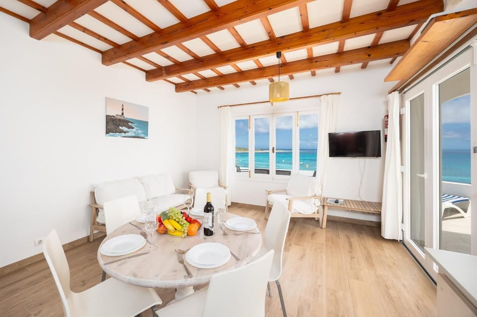 Living room with seating, dining area, kitchen, WiFi internet, satellite TV, and sea views