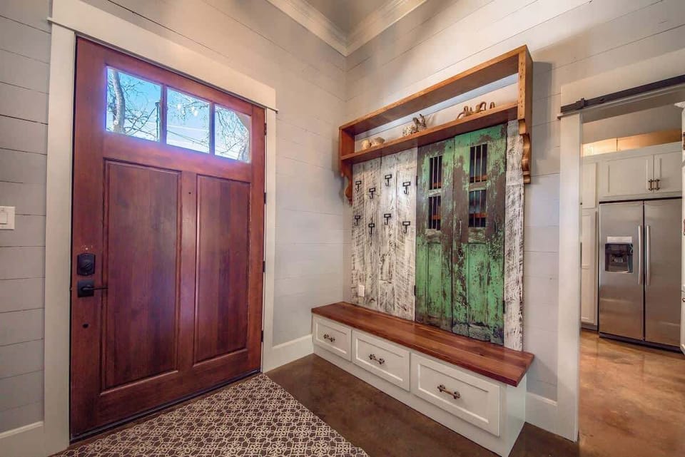Spacious entryway and laundry room located just off the foyer, featuring a second refrigerator and washer/dryer