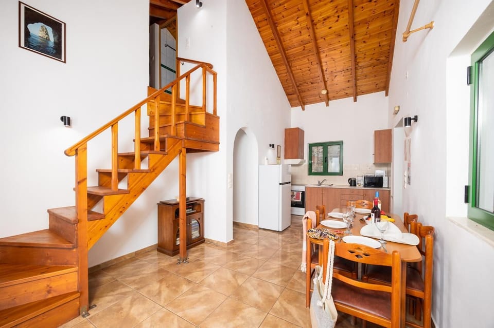Open-plan living room with dining area, kitchen, A/C, WiFi internet, satellite TV, and sea views