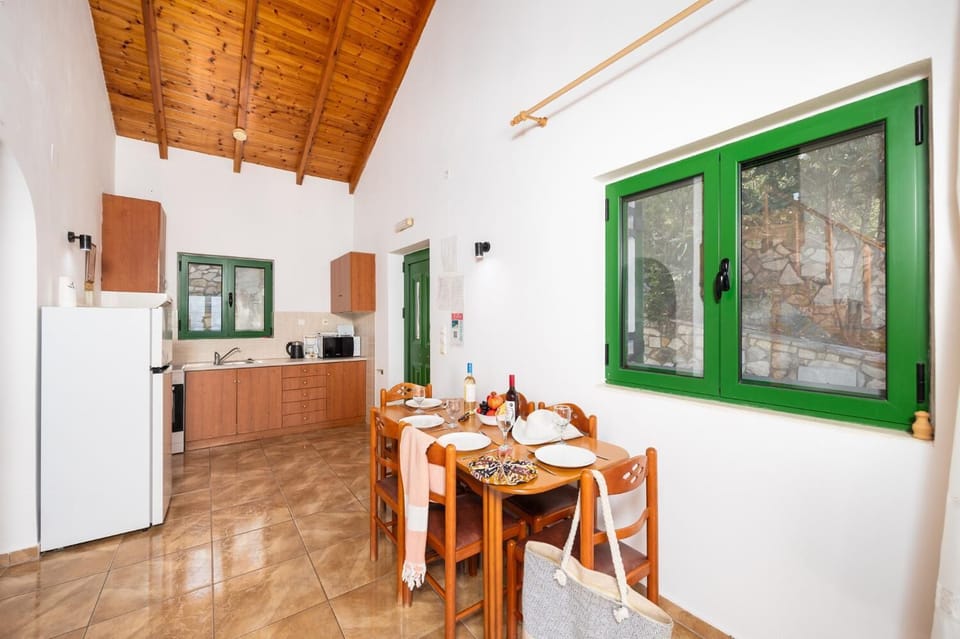 Open-plan living room with dining area, kitchen, A/C, WiFi internet, satellite TV, and sea views