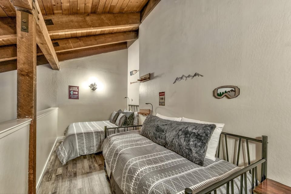 Drift off under rustic wooden beams in your cozy mountain-themed loft bedroom, where alpine charm meets modern comfort.