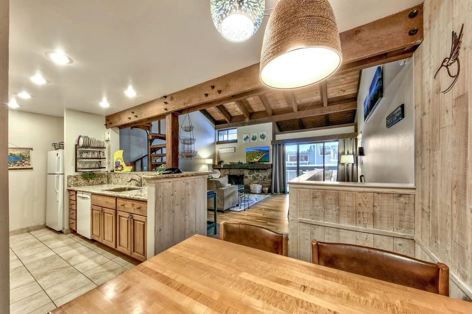 Gather around this stunning rustic kitchen where natural wood beams and granite countertops create the perfect space for preparing memorable meals together.