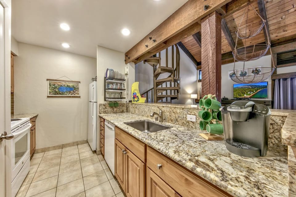 Your fully-equipped kitchen features granite counters, exposed beams, and everything needed for memorable meals during your stay.