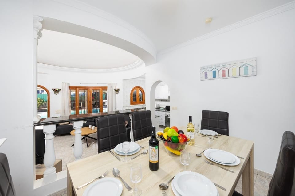 Open-plan living room with sofas, dining area, kitchen, WiFi internet, and satellite TV