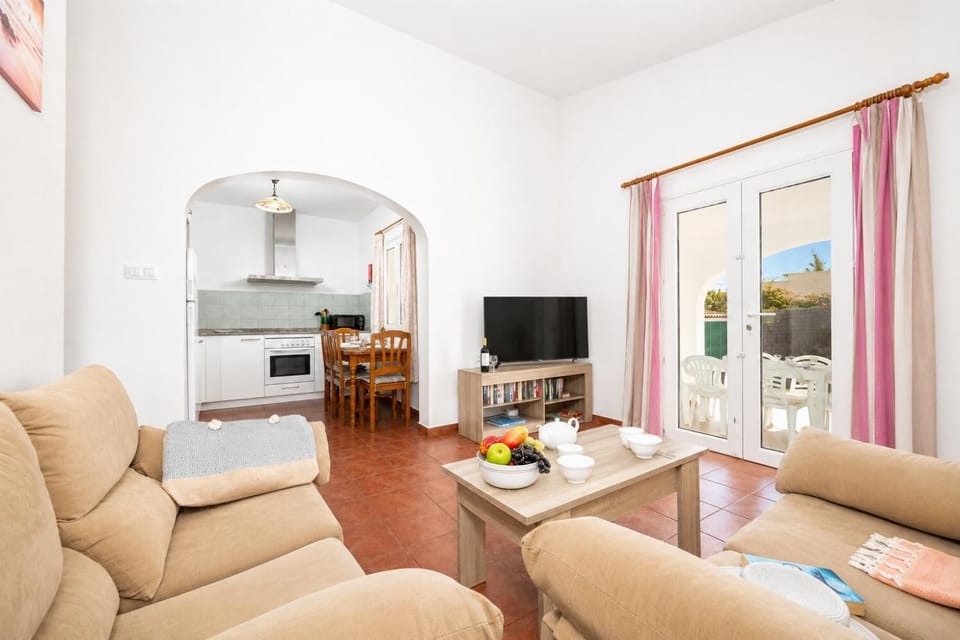 Open-plan living room with sofas, dining area, kitchen, WiFi internet, and satellite TV