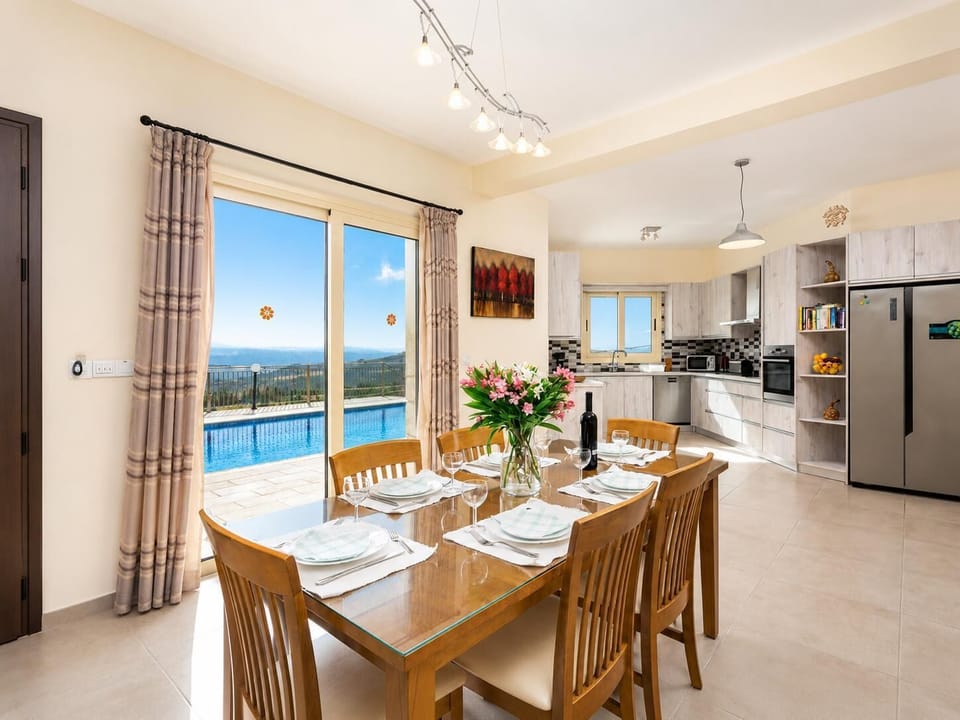 Open-plan living room on ground floor with sofas, dining area, kitchen, A/C, WiFi internet, satellite TV, views, and terrace access