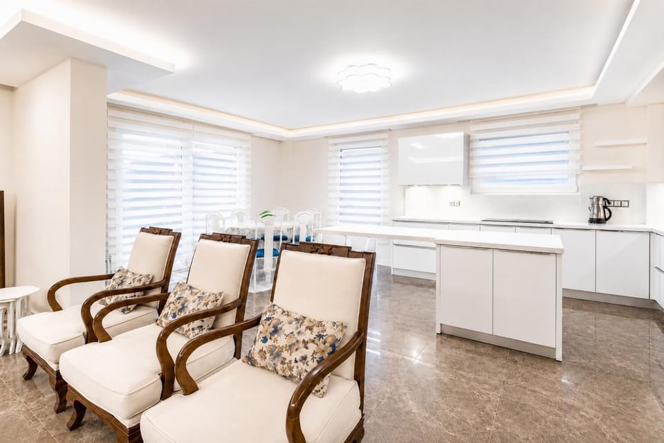 Open-plan living room with sofas, dining area, kitchen, A/C, WiFi internet, satellite TV, and pool terrace access